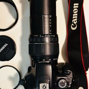 Canon DSLR with Black Tamron Zoom Lens and Red-Trim Strap